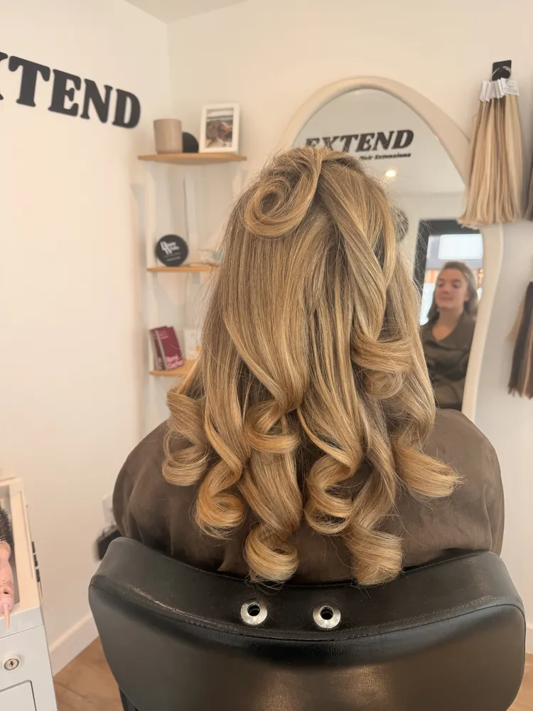 Blonde extensions styled in pin curls